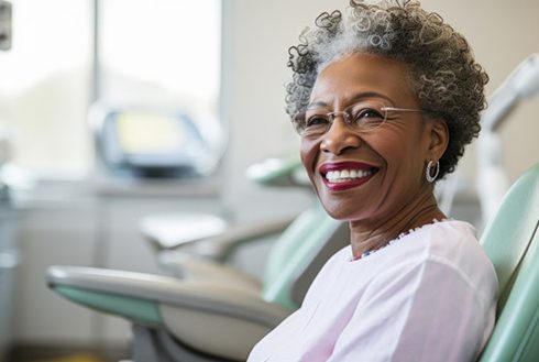 a patient smiling after receiving her new smile