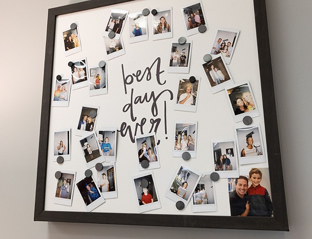 Board on wall with several photos of families visiting Upper Arlington dental office