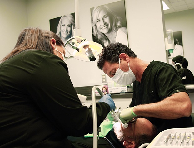 Dentist and assistant treating a dental patient