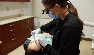 Dental team member giving a patient a dental exam
