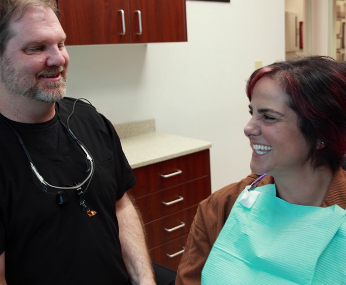 Doctor Bell talking to a patient in the dental chair