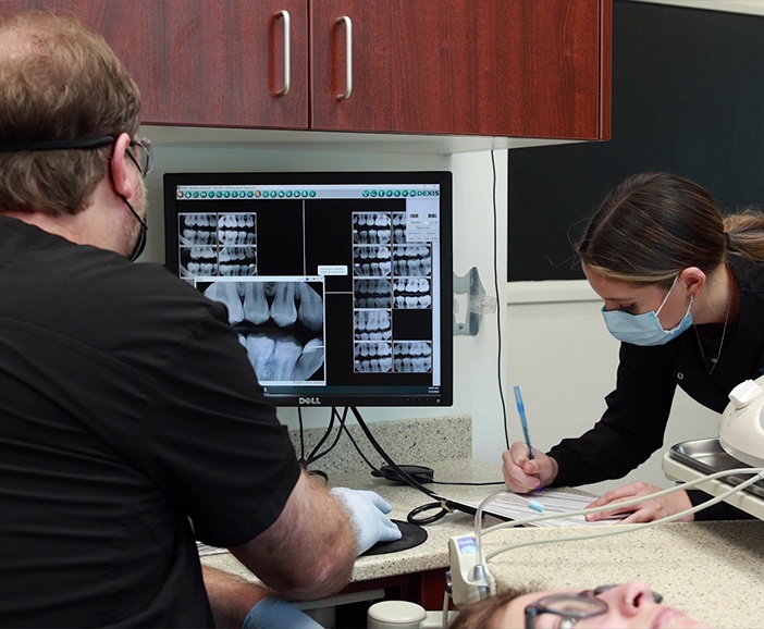 Upper Arlington emergency dentist looking at x rays during dental appointment
