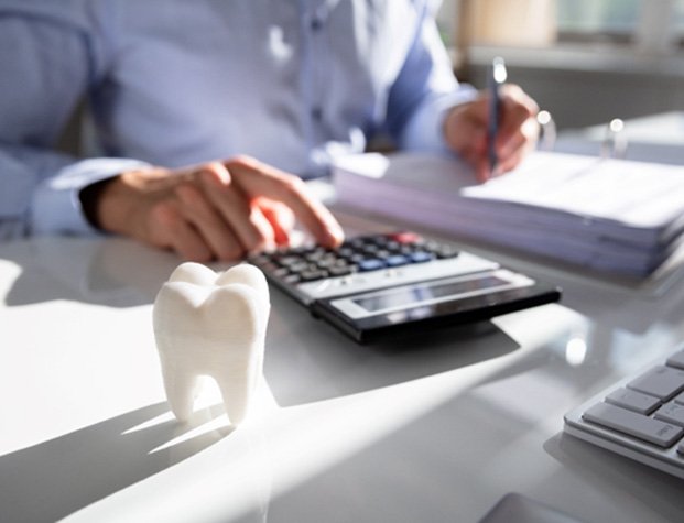 Patient using calculator to determine cost at desk