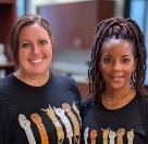 Two smiling dental team members