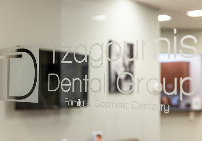 Tzagournis Dental Group of Upper Arlington logo on glass front door