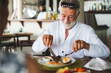 a person with dentures biting into an apple